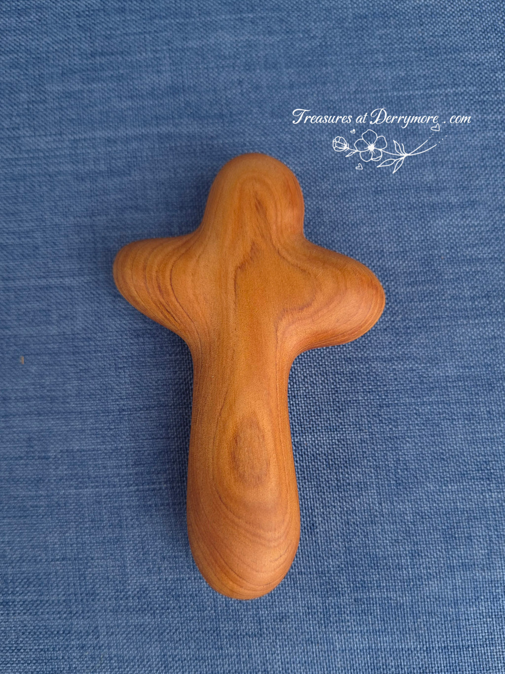 Hand carved wooden comfort cross on denim