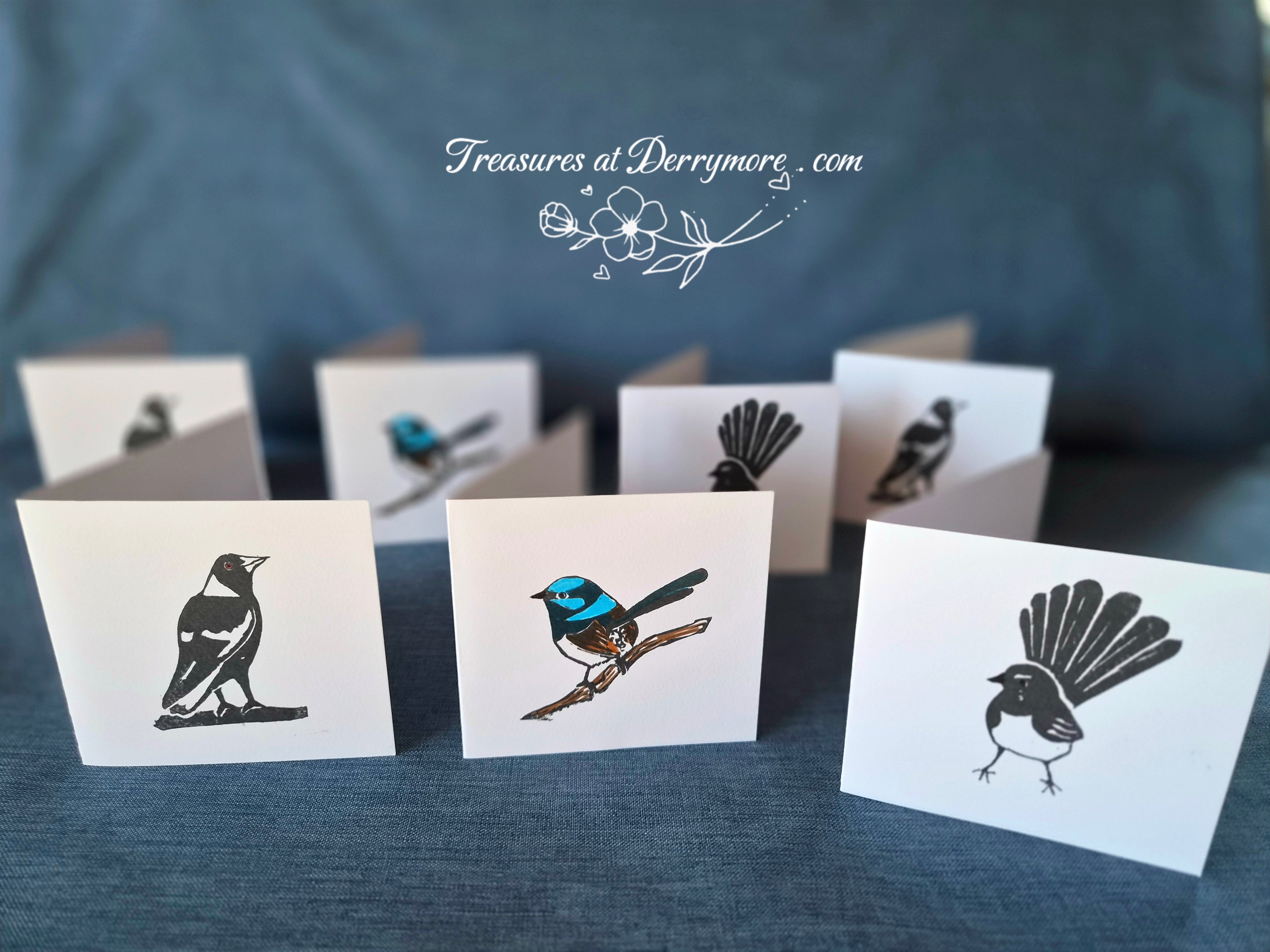 Set of cards with bird illustrations on a blue fabric background