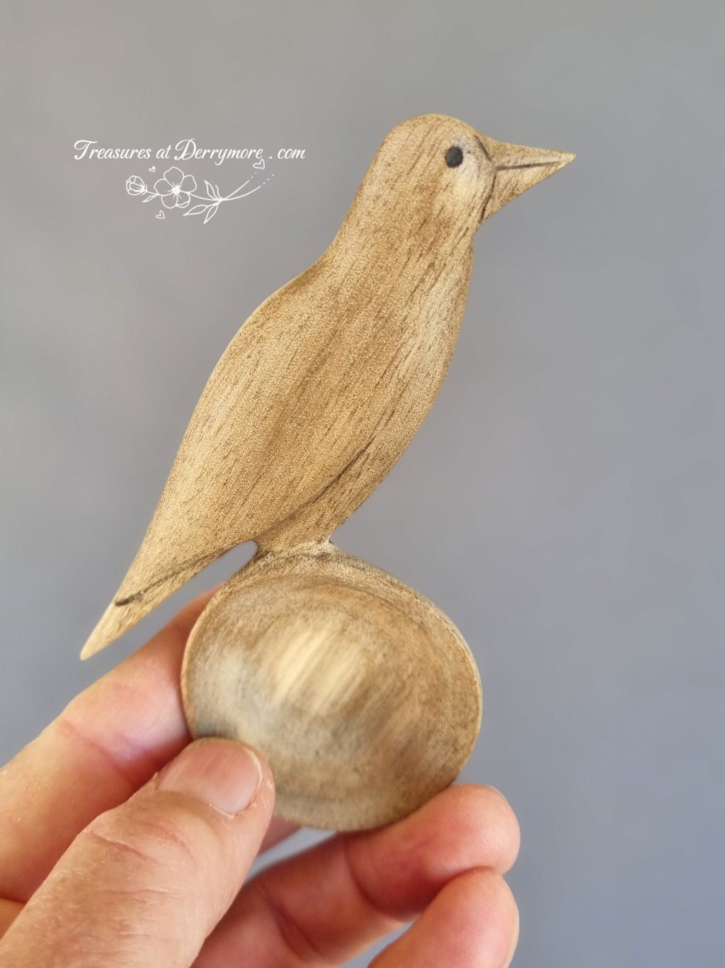Hand carved Australian Magpie spoon held in the hand