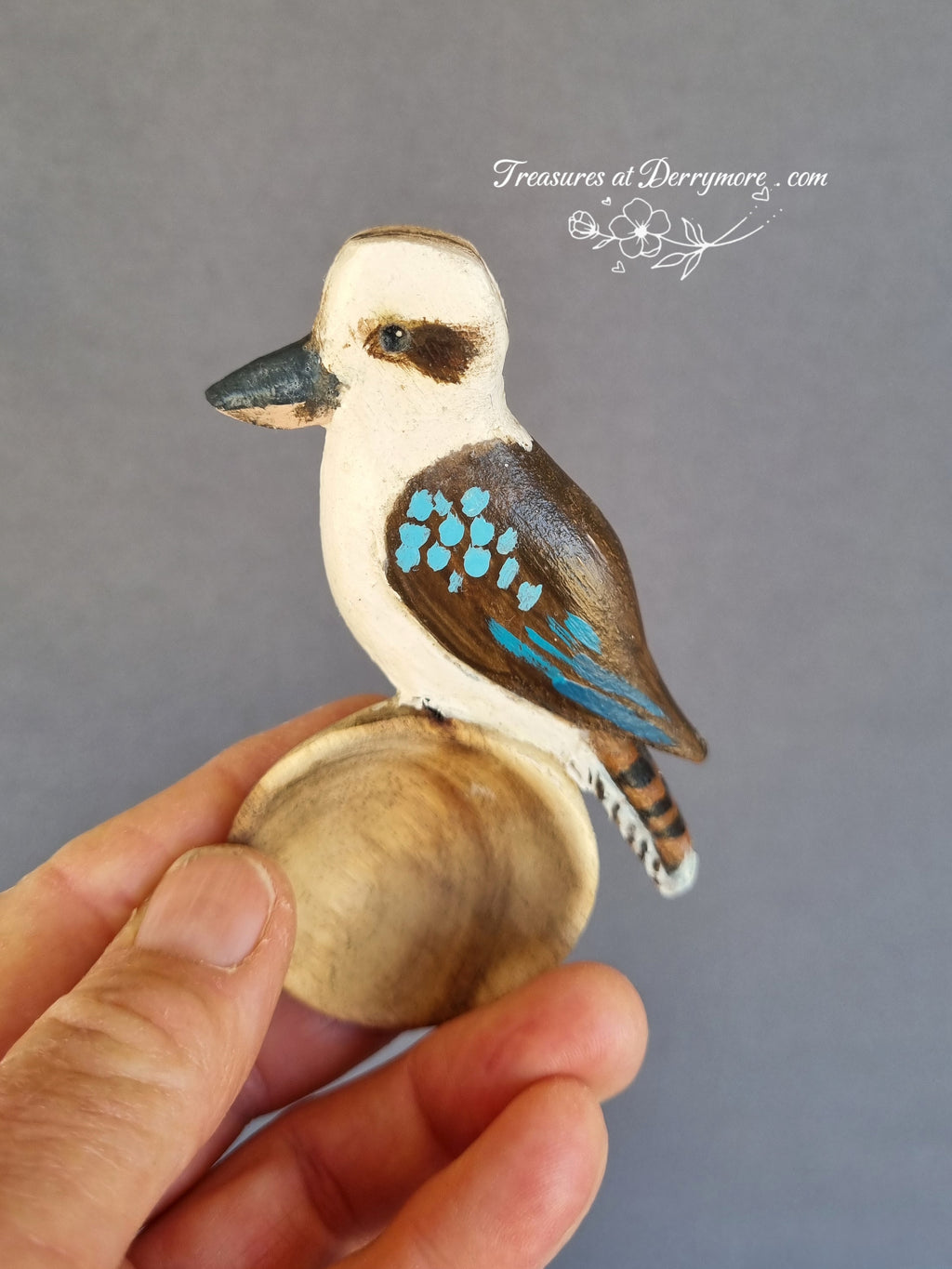 Hand carved painted kookaburra spoon held in hand