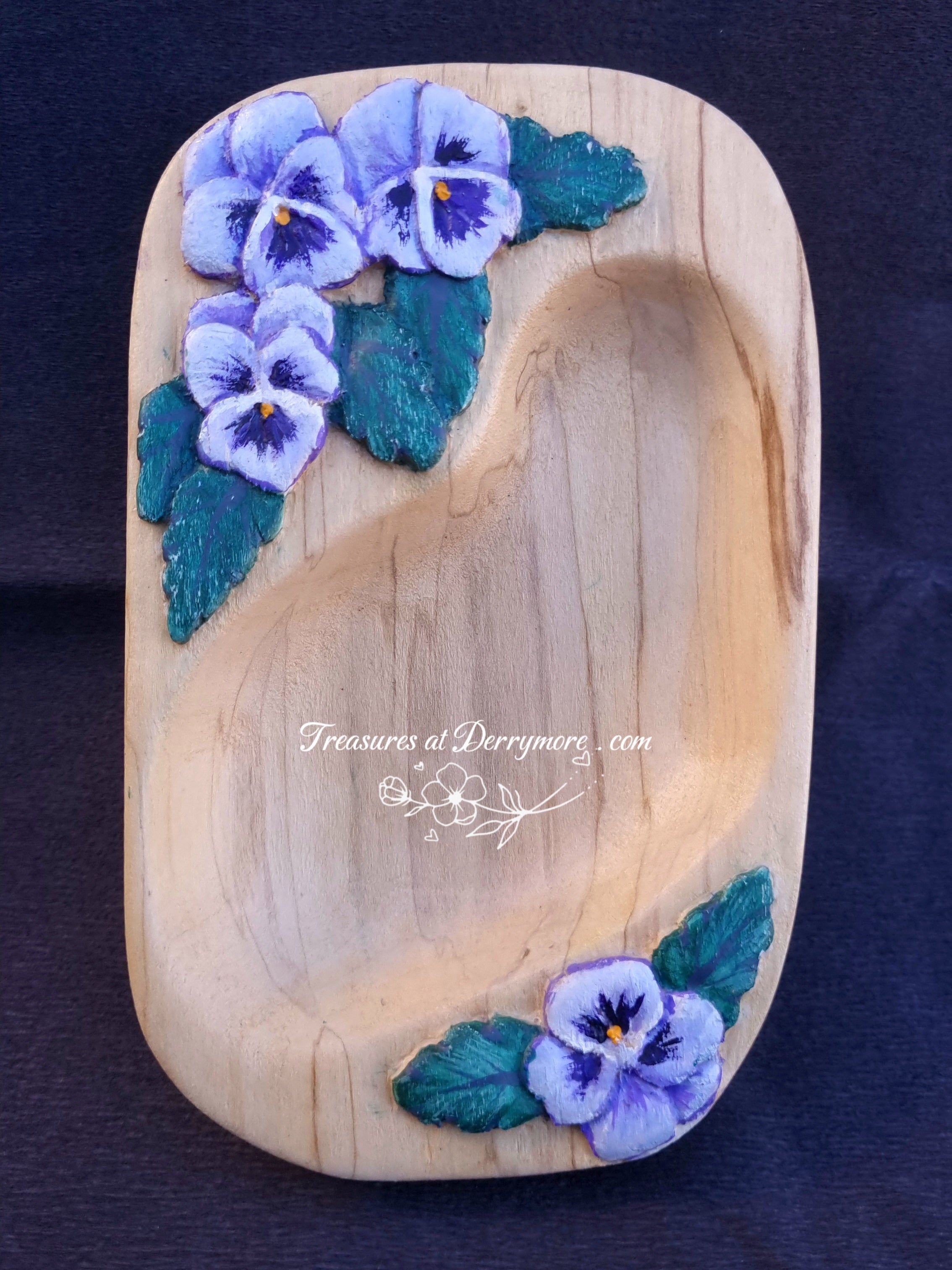 Hand carved long wooden dish with relief carved pansy flowers painted purple. The wooden dish is natural wood 