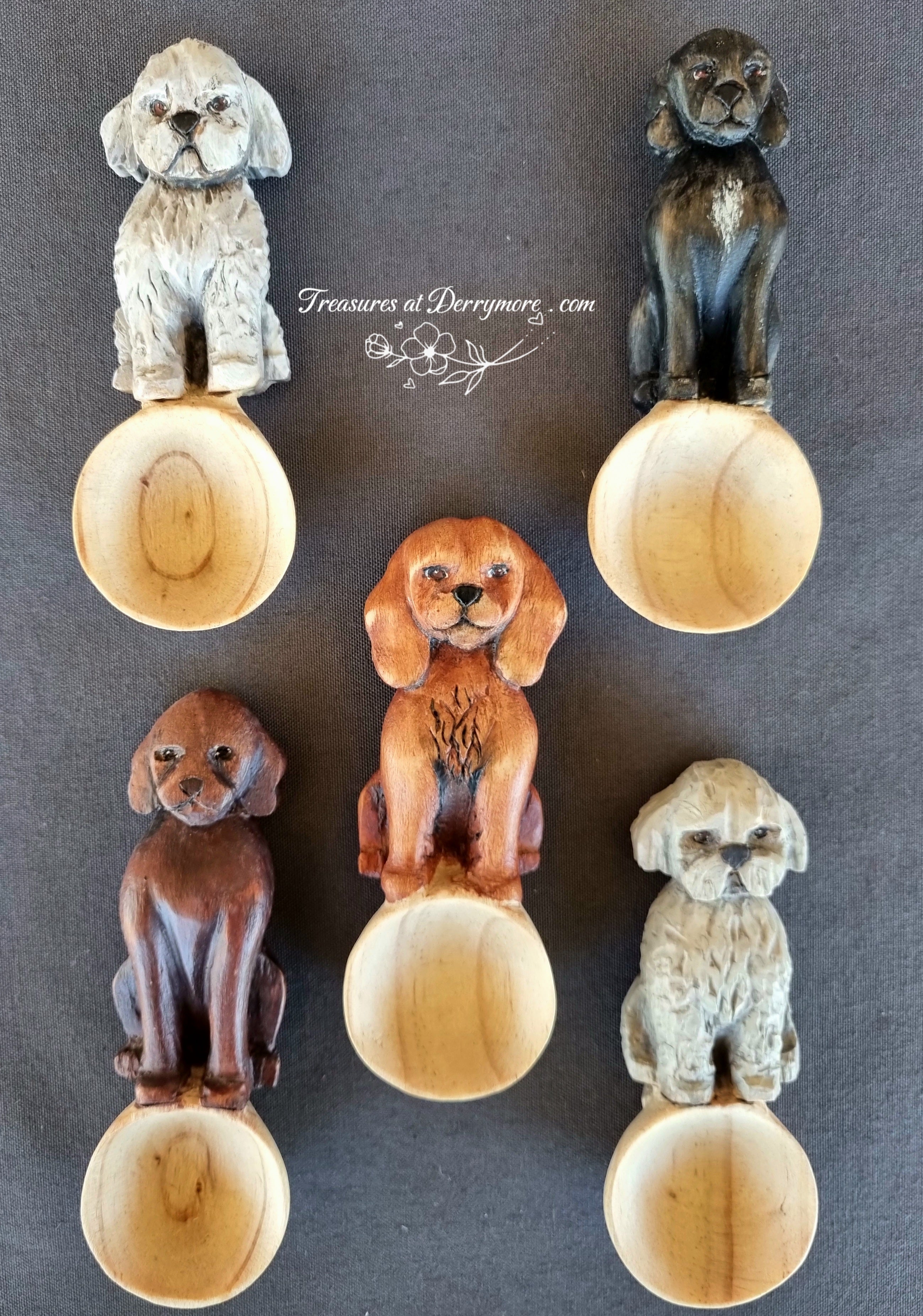 Five wooden dog-shaped spoons on a gray background with 'Treasures at Derrymore' branding.