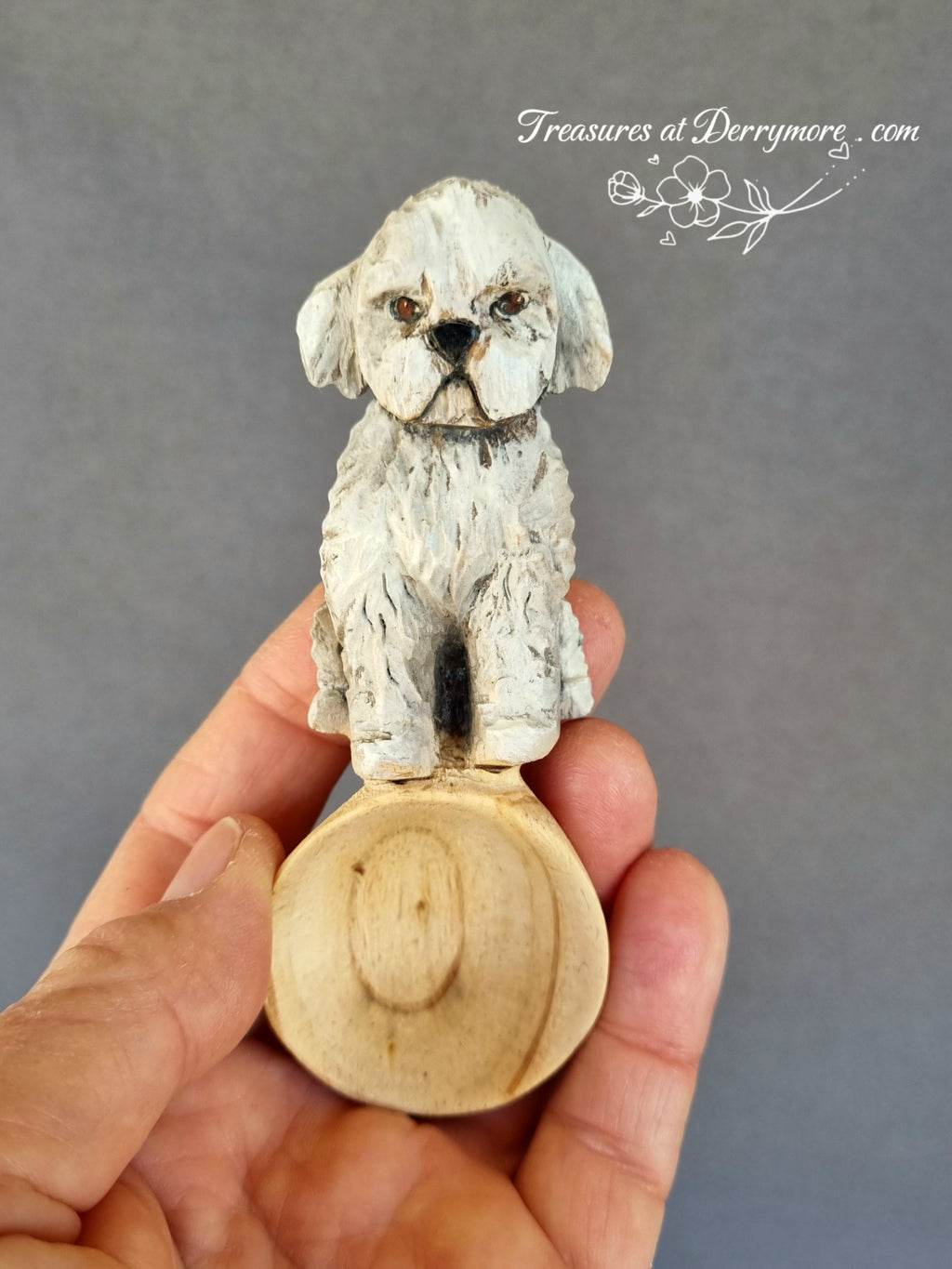 Hand carved wooden spoon with carved handle of painted small white & grey dog held in hand