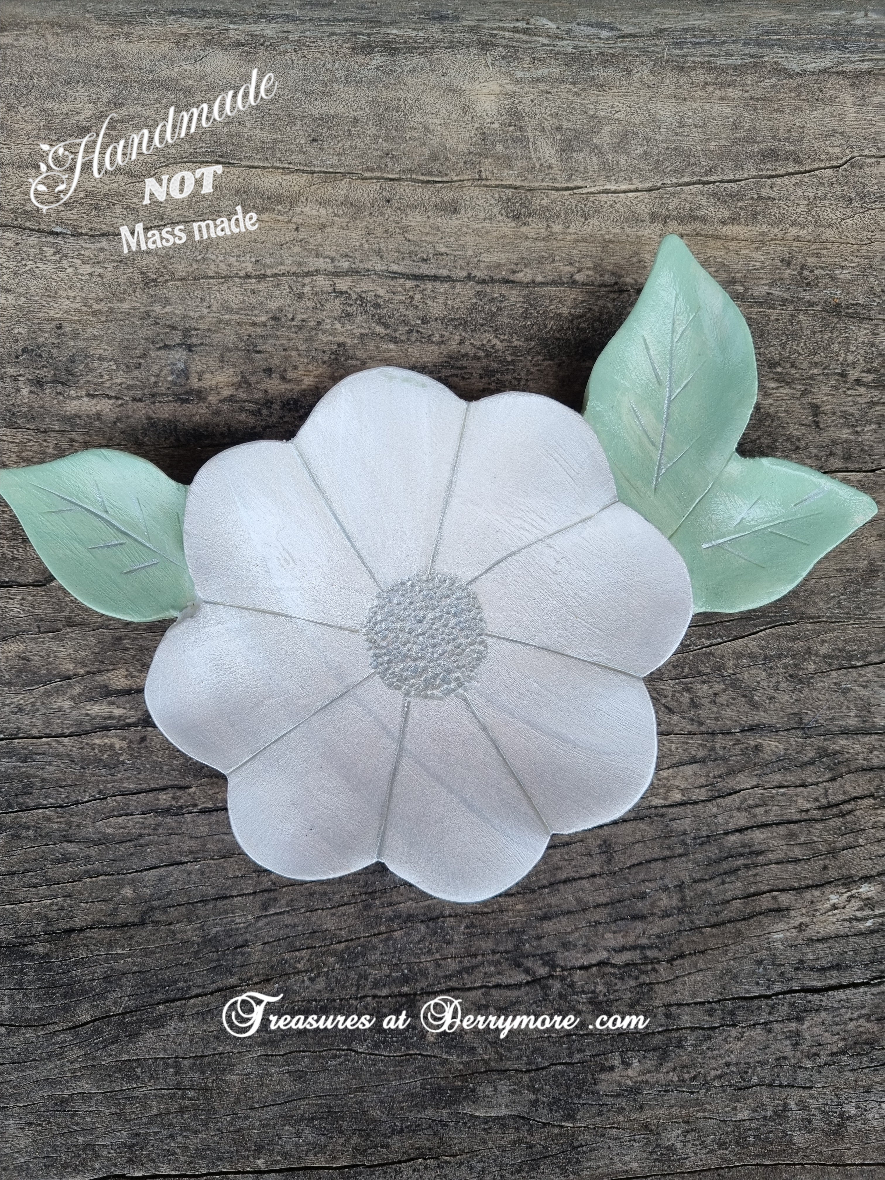 Hand carved and painted white flower shaped dish with green carved leaves
